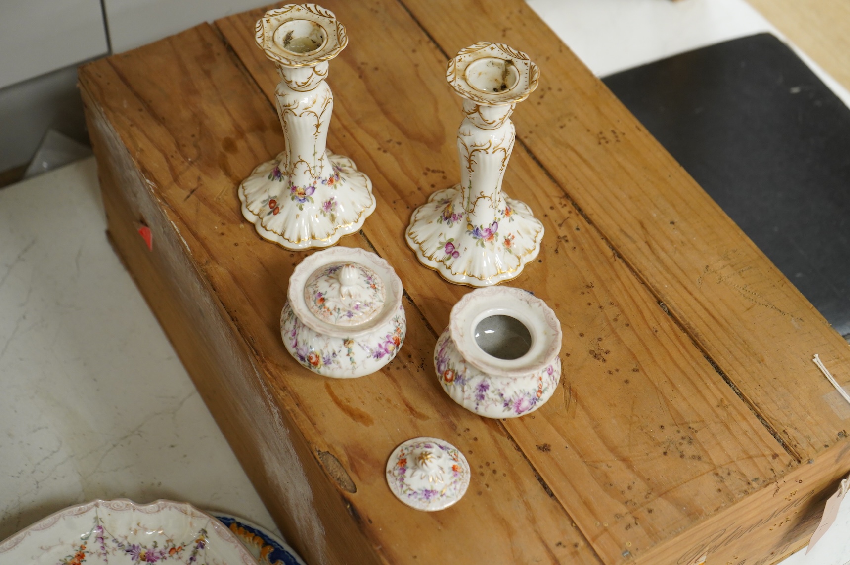A late 19th century Dresden ink stand and a pair of candlesticks and a Nove faience dish